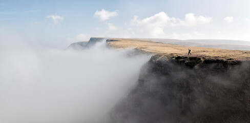 UK, Wales, Brecon Beacons, Young woman hiking at Bannau Sir Gaer Ridge