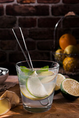 Glass of detox water with mint, ginger, rosmary and limes