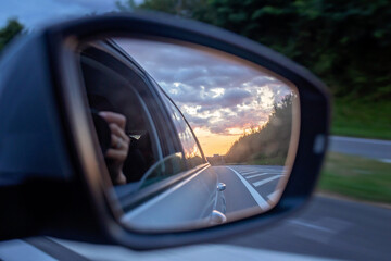 Sunset in car mirror, reflection from the nature