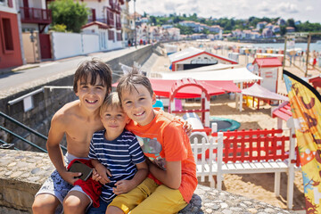 Family, visiting small town in France, Saint Jean de Luz, during summer vacation, traveling with...