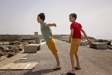 Cute child from european amily, visiting the most south point of Europe, Tarifa in Spain. Heavy...