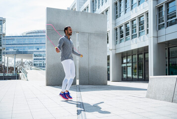 Man skipping rope in the city