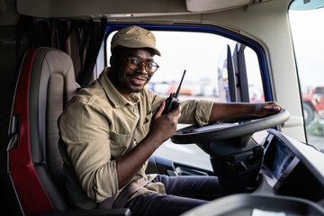 Professional driver in truck vehicle holding steering wheel.
