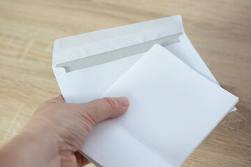 close-up shot of female hand holding white paper envelope, receiving Mail, letter, message concept,...
