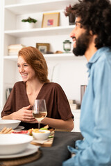 Friends having fun at a dinner party, enjoying eating together