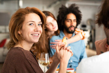 Friends having fun at a dinner party, enjoying eating together