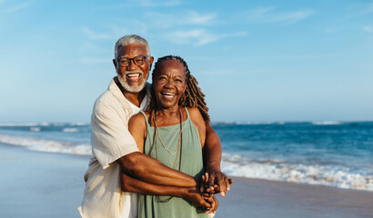 Happy mature couple embracing on a sunny beach