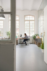 Woman working at desk in a loft office