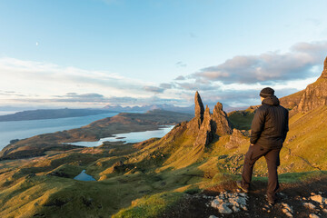 UK, Scotland, Inner Hebrides, Isle of Skye, Trotternish, tourist on peak near The Storr