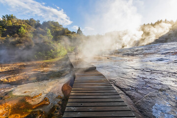Tourist on wooden boardwalk, Emerald Terrace, Orakei Korako Geothermal Park, Taupo Volcanic Zone,...