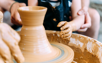Close-up of father and daughter in a pottery workshop