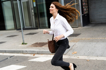 Businesswoman running in the street