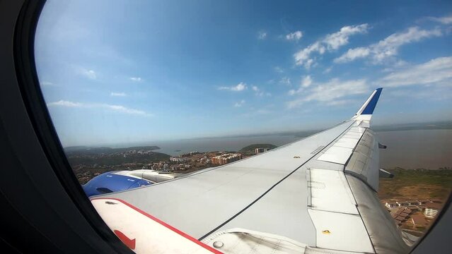 View through plane window while landing in Goa, India