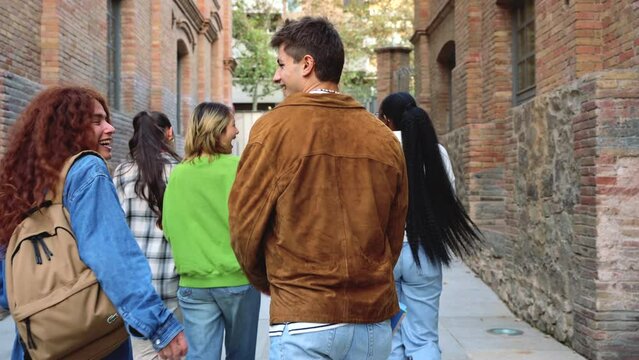  Group Of Multiracial Students Walk On Their Way To College Warning Their Classmates Behind