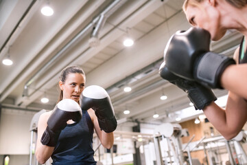 Young women boxing in gym