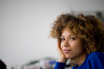 Portrait of smiling woman with hand on face