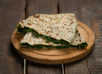 traditional pie with herbs and cheese on wooden board .jingyal