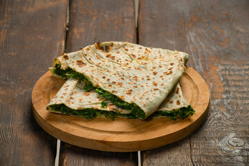 traditional pie with herbs and cheese on wooden board .jingyal