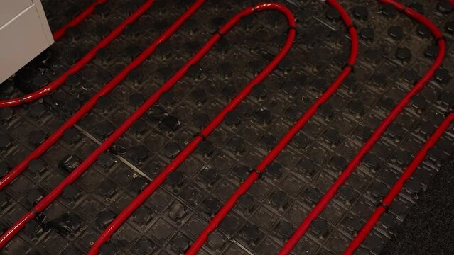 Underfloor heating with red piping for energy efficiency and warmth in modern homes