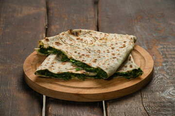 traditional pie with herbs and cheese on wooden board .jingyal