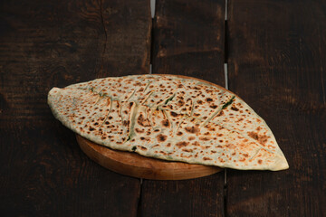 traditional pie with herbs and cheese on wooden board .jingyal