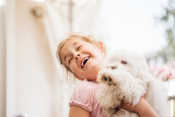 Happy girl playing with dog