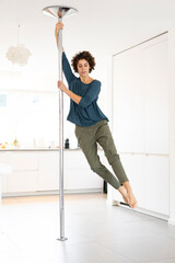 Woman doing pole dance at home