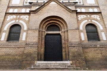 Fototapeta premium One of the side entrances of the Synagogue of Novi Sad between two stained glass windows, Novi Sad, Serbia