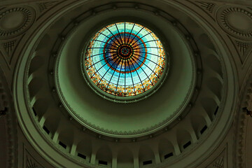 Inside the Synagogue of Novi Sad looking up to the ceiling, colorful stained glass dome, cupola,...