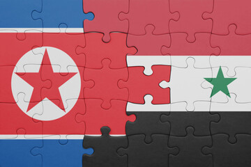 puzzle with the colourful national flag of syria and flag of north korea .