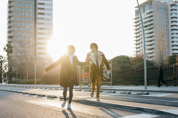 Happy couple running in the city at sunset