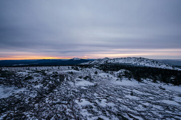 a beautiful pink sunset in the winter snow-capped mountains of the Urals