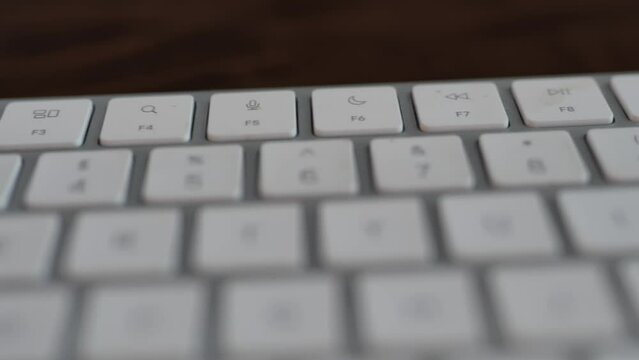 Function buttons on a white keyboard. Close up of F1 to F12 buttons