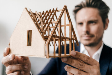 Close-up of architect examining architectural model