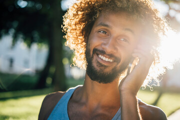 Portrait of smiling young man on cell phone