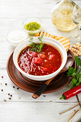 Russian borscht in a white bowl soup food on light wood