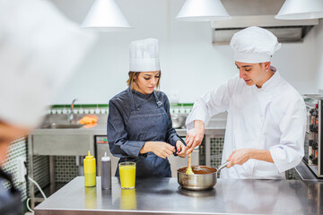 Junior chefs stirring chocolate sauce