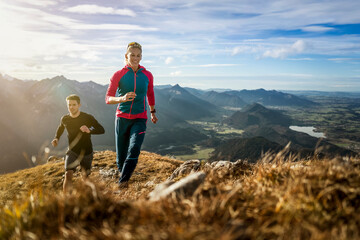 Sports people practicing trail running on mountain path of Saulingspitze at Bavaria, Germany © tunedin