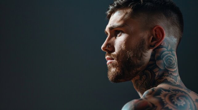 Back view of tattoed bodybuilder with outstretched arms