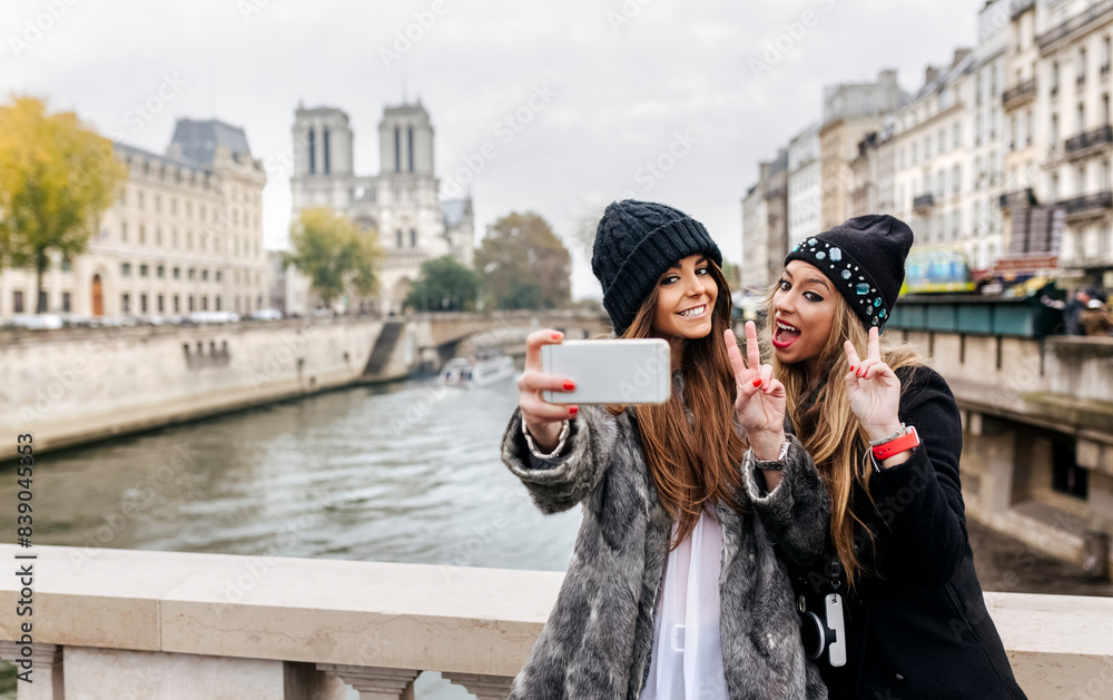 Wall mural france, paris, tourists taking selfie with cell phone