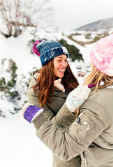 Two friends having fun in the snow