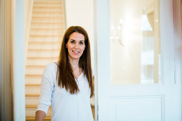 Portrait of smiling woman at home
