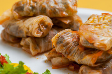 delicious dish of dolma with cabbage and vegetables on white plate