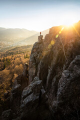 Man standing on rock needle at sunset at Battert rock, Baden-Baden, Germany