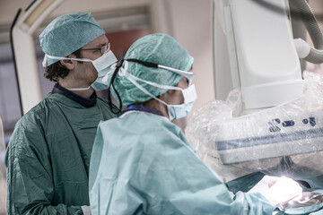 Neuroradiologist with assistant in scrubs