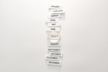 White tiles with the months of the year, July highlighted in the center.