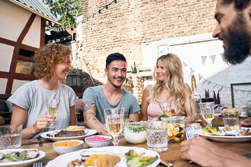 Friends having fun at a barbecue party, eating together
