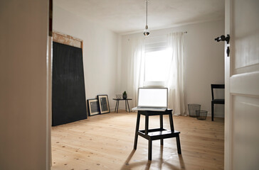 Laptop on stool in a modern furnished room