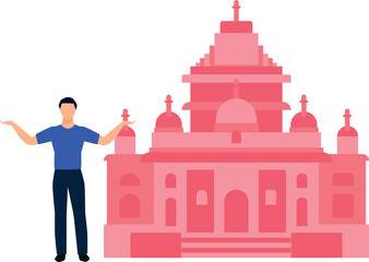 The boy is standing in front of the mosque.