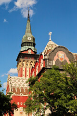 Upper facade and clock tower of the city hall, town hall on a sunny day, an example of Art Nouveau...